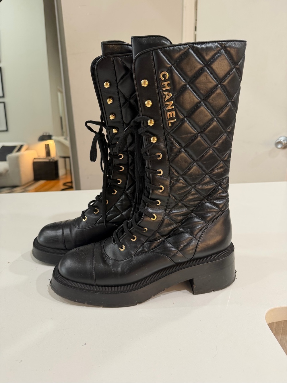 CHANEL Black Quilted Leather Lace-Up Knee Boots with Gold Logo
